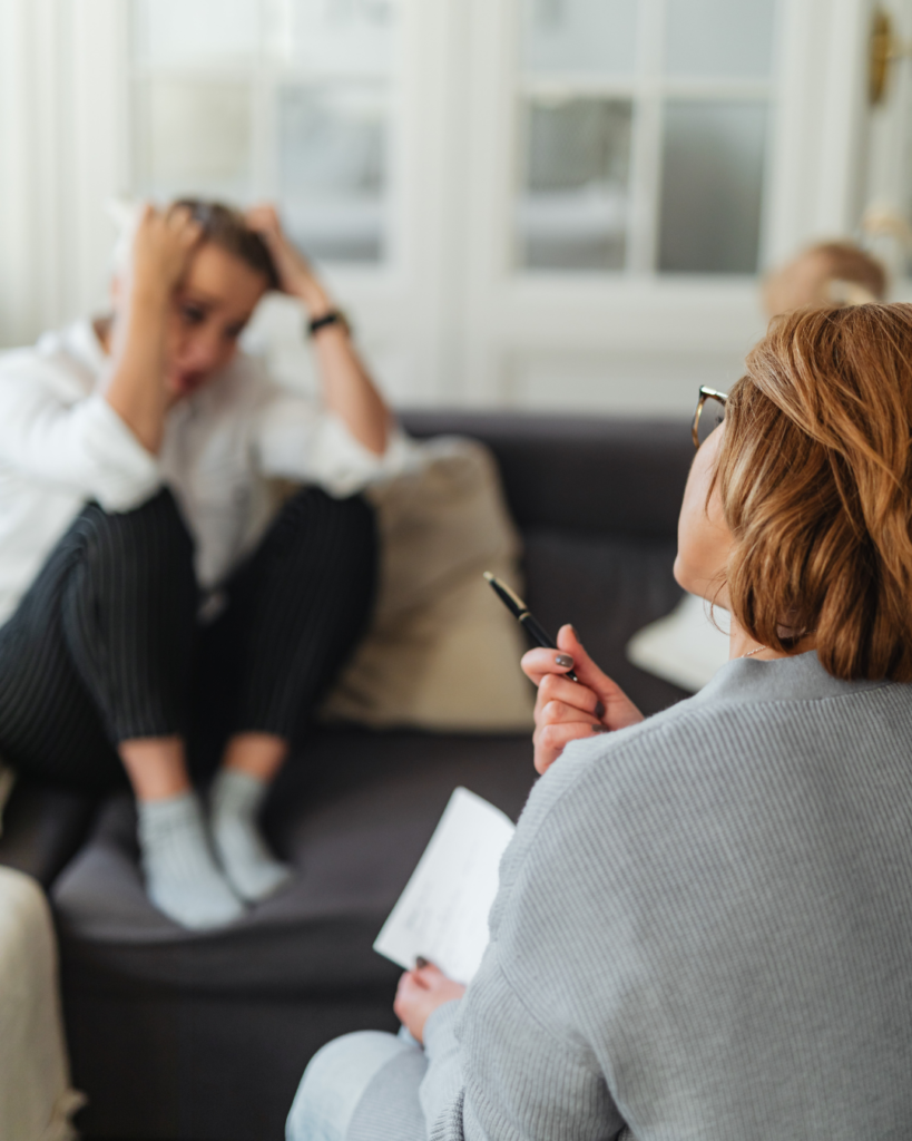 Woman on couch talking to a therapist